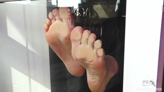 My barefoot wrinkled soles rubbing against the glass and squeezing juicy strawberries
