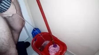 John is taking a Piss into the Cleaning Bucket