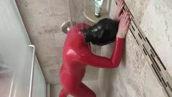 Rubberdoll showers in red catsuit