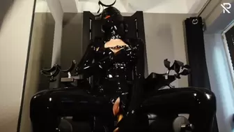 Rubberslut with Heavy Rubber Helmet fucking her twat on slave chair