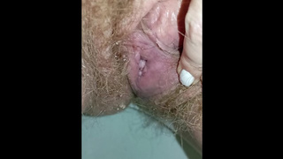 Bushy snatch whore peeing in the toilet with a sanitary pad in her panties